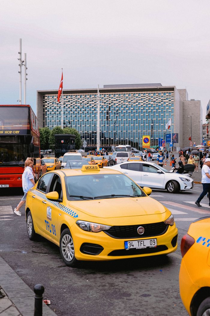 gallery-6 Yellow taxis and bustling street scene in front of a modern building in Istanbul, Turkey.