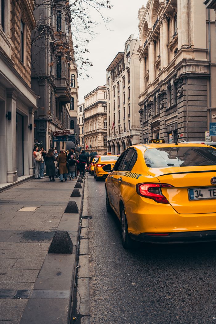 services-02 Yellow taxis line a historic street in Istanbul, embodying urban life in Turkey's bustling city.